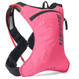 USWE Race 2.0 lightweight hydration pack in pink with black mesh shoulder straps and minimal storage for cross-country mountain biking and gravel racing.